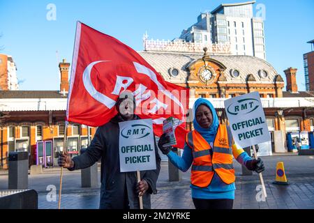 Slough, Berkshire, UK. 14th December, 2022. Rail staff from Slough Station were picketing outside Slough railway station today in the freezing cold on another day of sub zero temperatures in a dispute over pay and the planned closure of ticket offices. GWR trains and Elizabeth Line trains were running to and from London but the station was much quieter than normal as many people decided to work from home. Credit: Maureen McLean/Alamy Live News Stock Photo