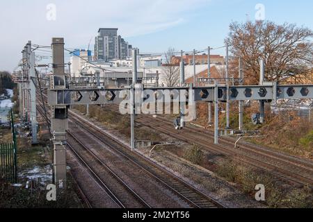 Slough, Berkshire, UK. 14th December, 2022. The electrified railway line at Slough. Some rail workers were on strike today at Slough Railway Station in a dispute over pay and the planned closure of ticket offices. GWR trains and Elizabeth Line trains were running to and from London but the station was much quieter than normal as many people decided to work from home. Credit: Maureen McLean/Alamy Live News Stock Photo