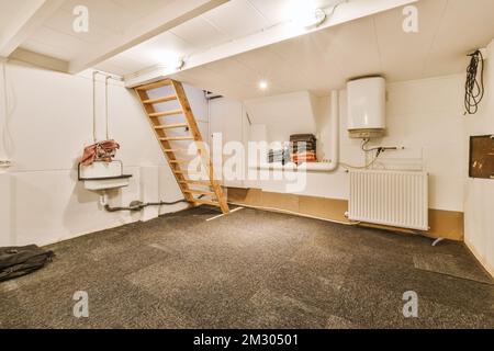a room that is being used as a storage for clothes and other things in it has been taken from the attic Stock Photo