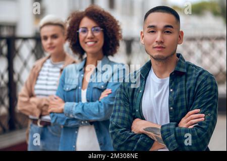 Guy in the company of ladies on the veranda Stock Photo