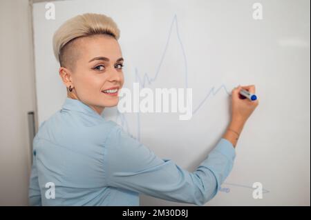 Joyous businesswoman posing for the camera during the presentation Stock Photo