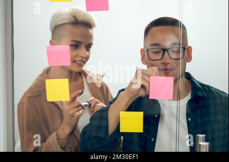 Office worker sharing ideas with his coworker Stock Photo