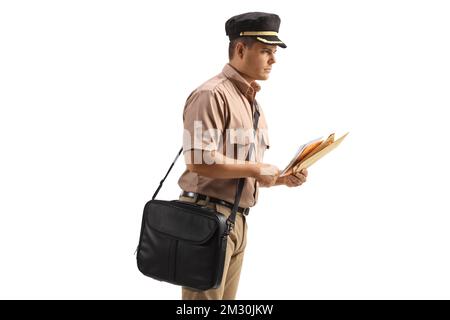 Profile shot of a mailman with a bag delivering letters isolated on white background Stock Photo