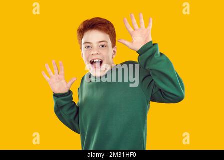 Little child looking at something unexpected with happy surprised face expression Stock Photo