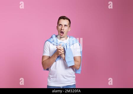 young guy in white t-shirt and blue sweatshirt Stock Photo