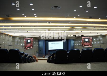 Huge and luxurious University auditorium chairs with presentation big screen. Blue theatre chairs. Stock Photo