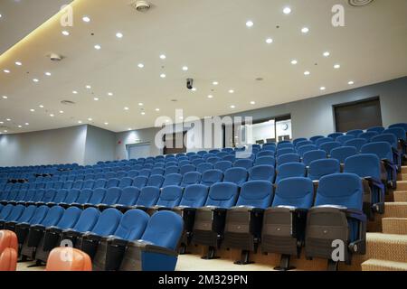 Huge and luxurious University auditorium chairs. Blue theatre chairs. Stock Photo