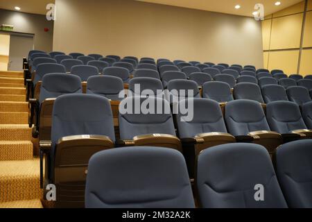 Huge and luxurious University auditorium chairs. Blue theatre chairs. Stock Photo