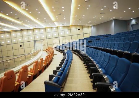 Huge and luxurious University auditorium chairs. Blue theatre chairs. Stock Photo