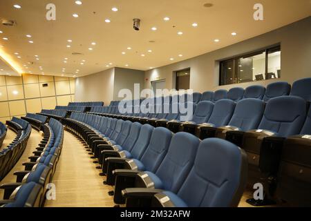 Huge and luxurious University auditorium chairs. Blue theatre chairs. Stock Photo