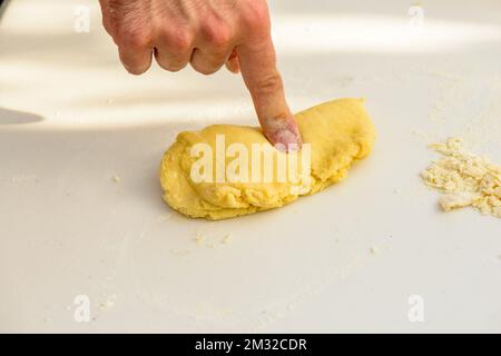 Pasta making - An instructor chef makes the dough handmade pasta in a Tenuta Torciano winery vineyard in Tuscany Italy Stock Photo