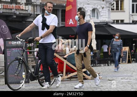 Illustration picture shows persons wearing masks in the city center of Antwerp, Monday 27 July 2020. The Covid-19 contamination numbers are rising again in Belgium. The National Security Council has announced more strict coronavirus measures as from tomorrow, in an attempt to try and keep the contamonation level low. BELGA PHOTO DIRK WAEM  Stock Photo