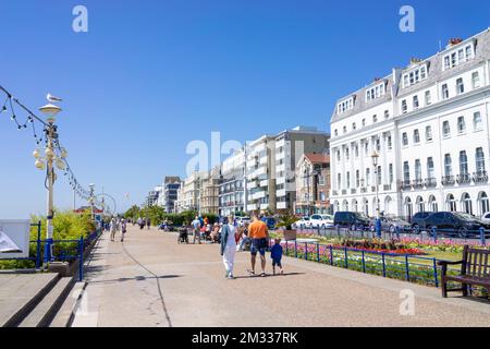 Eastbourne East Sussex Burlington Hotel on the seafront promenade people walking past the Carpet gardens Eastbourne East Sussex England GB UK Europe Stock Photo