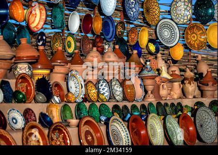 Tazentout, Ouarzazate, Morocco - November 28, 2022 - A set of traditional, handmade Moroccan clay dishes in the local shop. Bowls, plates, tagines, ju Stock Photo