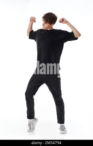 young man in black t-shirt and jeans dancing Stock Photo