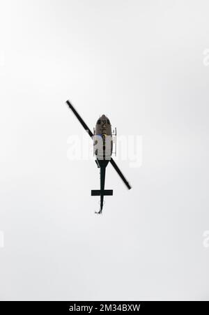 Police Helicopter flying over people during colombian independence day Stock Photo