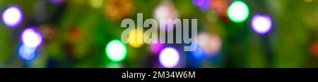 Out of focus image of a Christmas tree decorated with colorful ornaments and lights. Stock Photo
