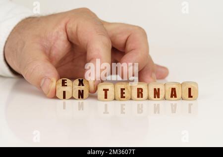 The man has cubes in his hands that form the words external - internal. Business concept Stock Photo