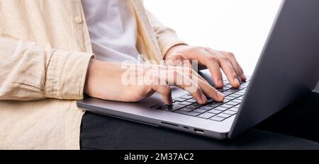 Male hands on laptop keyboard Stock Photo