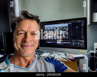 The happy old man working on the computer. Stock Photo