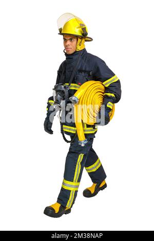 Fireman goes away in profile with fire hose in his hand. Stock Photo