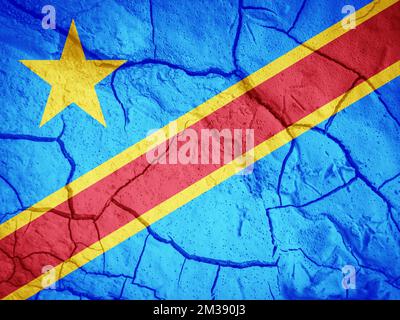 Flag of Democratic Republic of the Congo. Congo symbol. Flag on the background of dry cracked earth. Congo flag with drought concept Stock Photo