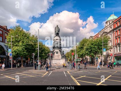 The lower end of O'Connell Street with the Daniel O'Connell memorial. Picture taken from the O'Connell bridge, looking north. Dublin, Ireland. Stock Photo