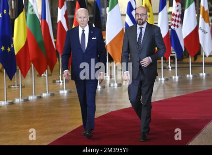 US President Joe Biden and European Council President Charles Michel seen through European and US flags, as they arrive for a meeting of European council, in Brussels, Thursday 24 March 2022, at the European Union headquarters in Brussels. The European Council will discuss the Russian military aggression against Ukraine, security and defence, energy, economic issues, COVID-19 and external relations. BELGA PHOTO POOL DIDIER LEBRUN  Stock Photo