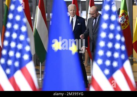 US President Joe Biden and European Council President Charles Michel seen through European and US flags, as they arrive for a meeting of European council, in Brussels, Thursday 24 March 2022, at the European Union headquarters in Brussels. The European Council will discuss the Russian military aggression against Ukraine, security and defence, energy, economic issues, COVID-19 and external relations. BELGA PHOTO POOL DIDIER LEBRUN  Stock Photo