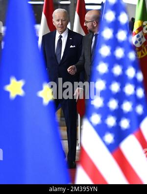 US President Joe Biden and European Council President Charles Michel seen through European and US flags, as they arrive for a meeting of European council, in Brussels, Thursday 24 March 2022, at the European Union headquarters in Brussels. The European Council will discuss the Russian military aggression against Ukraine, security and defence, energy, economic issues, COVID-19 and external relations. BELGA PHOTO POOL DIDIER LEBRUN  Stock Photo