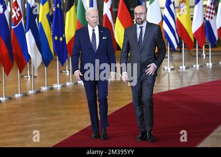 US President Joe Biden and European Council President Charles Michel seen through European and US flags, as they arrive for a meeting of European council, in Brussels, Thursday 24 March 2022, at the European Union headquarters in Brussels. The European Council will discuss the Russian military aggression against Ukraine, security and defence, energy, economic issues, COVID-19 and external relations. BELGA PHOTO POOL DIDIER LEBRUN  Stock Photo