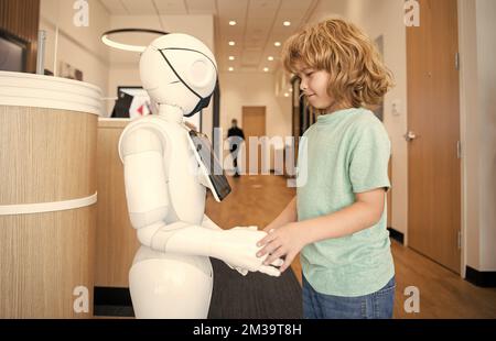 child interact with robot as innovative technology, communication Stock Photo