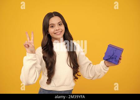 Cute teenager child girl congratulate with valentines day, giving romantic gift box. Present, greeting and gifting birthday concept. Happy face Stock Photo