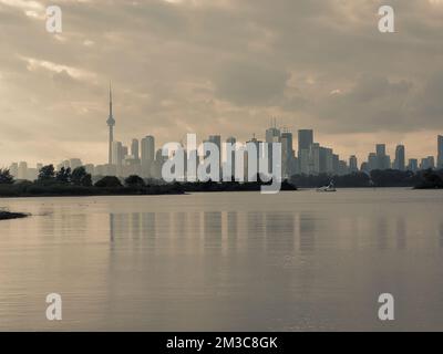 Autumn day view across inner bays of Lake Ontario in Tommy Thompson Park with foggy Downtown Toronto skyline under grey cloudy skies in the background Stock Photo