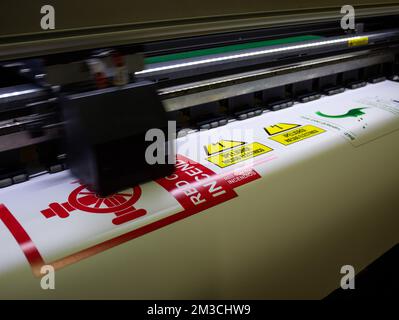 Wide-format Inkjet printing caution or publisher signs in spanish language, Plotter print Stock Photo