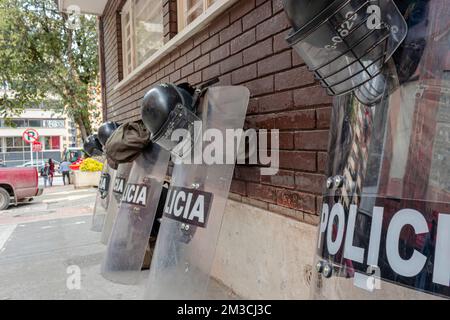 BOGOTA, COLOMBIA - Police Riot helmets and shields over a brick dark red wall waiting for disturbs Stock Photo