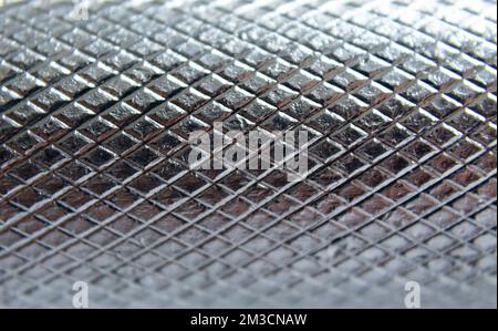 Macro photography to an iron geometric pattern of a dumbbell piece. Texture photo Stock Photo