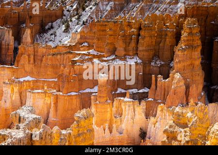 Close up view of bryce canyon national park hoodoos in winter in souther utah usa showing oranges and whites during the day. Stock Photo