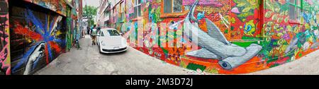 Panoramic photo of Toronto graffiti alley - Abstract colourful graffiti paintings on the alley.  Street art, background, texture. Stock Photo