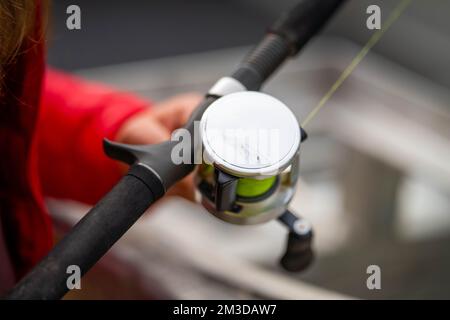 girl in a dinghy fishing with a fishing rod while camping in