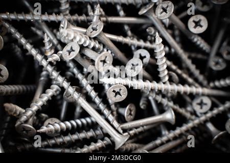 Long black wood screws close-up. Universal building materials Stock Photo