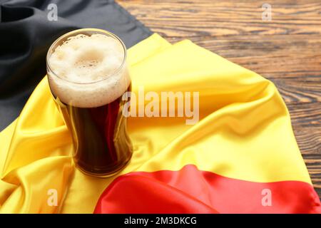 Belgium flag and glass of beer on wooden background Stock Photo