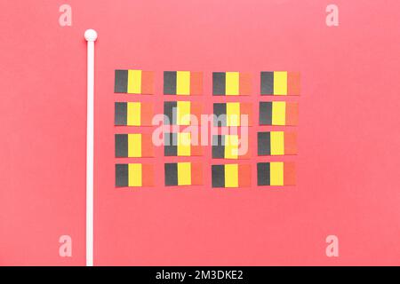 Small national Belgium flags on red background Stock Photo