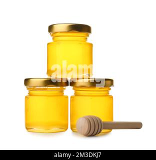 Tasty honey in jars and dipper on white background Stock Photo