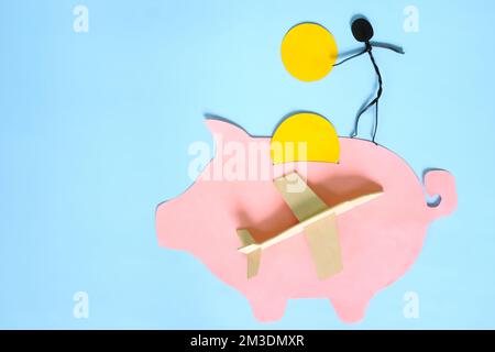 Saving for travel fund and vacation concept. Piggy bank with airplane model. Stock Photo
