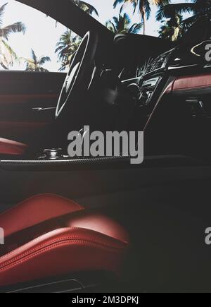 Modern  car  red  perforated leather interior. Part of  leather car seat details. Stock Photo
