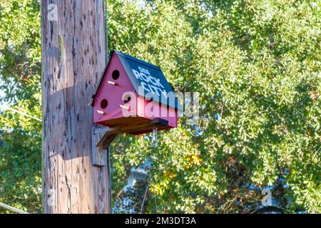 NEW ORLEANS, LA, USA - DECEMBER 7, 2022: Red and Black 'See Rock City' birdhouse on a utility pole in Uptown neighborhood Stock Photo