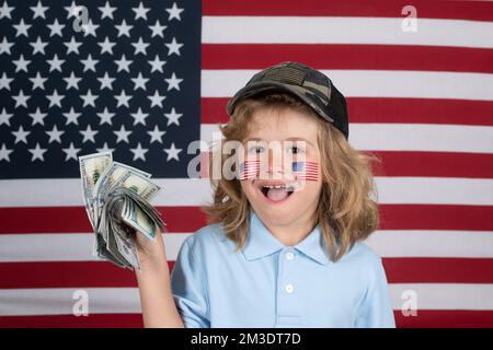 American money. Portrait of child with money banknotes. Kid with money. Children learning financial responsibility about saving money. American flag Stock Photo