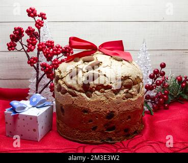 Traditional Christmas Panettone. Famous Italian dessert with Christmas ornaments isolated on wooden background Stock Photo