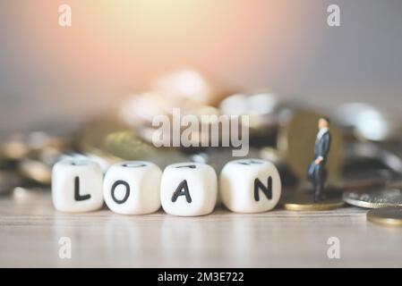 Loan business economy concept of money and finance, on table, Loan business finance economy and business man standing on a coin on wooden table backgr Stock Photo